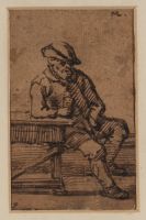 Man seated at a table with a glass of wine
