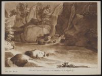 Rocks in a river in the foreground, with boulders and small waterfalls beyond