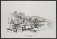 A barge on a canal with a castle on a hill