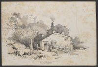 Stone houses in the foreground with a castle on a hill in the background